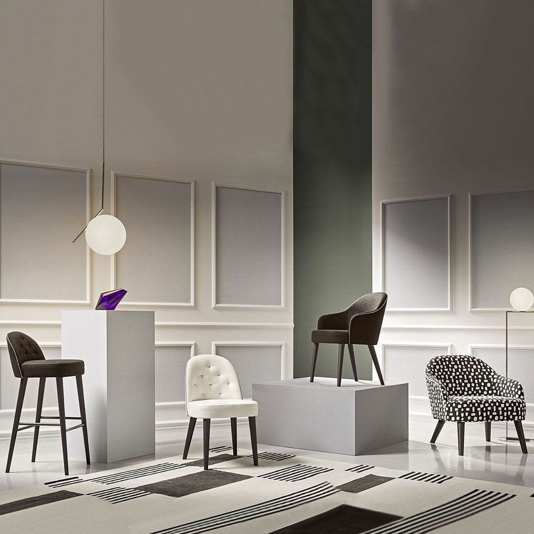 Stylish chairs in black, white, and patterned textures, showcased in a contemporary interior setting.