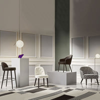 Stylish chairs in black, white, and patterned textures, showcased in a contemporary interior setting.