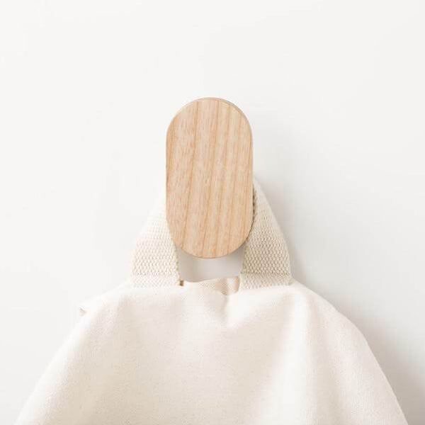 Cream-colored fabric bag with minimalist design, featuring soft textures and neutral tones.