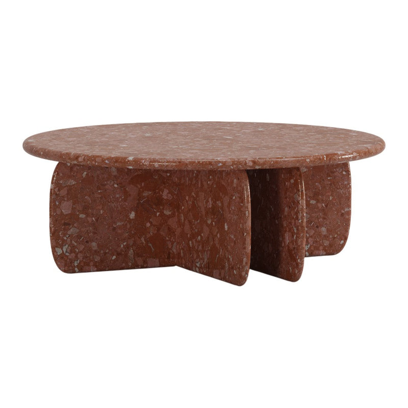 Round terracotta coffee table with a speckled texture and unique, bold shape. Perfect for modern home decor.