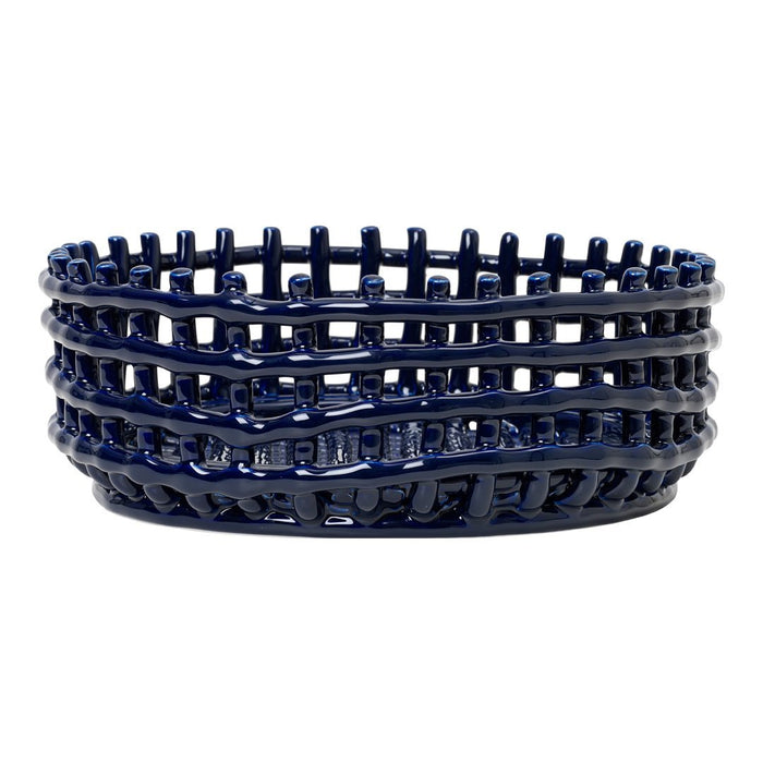 Navy blue ceramic basket with intricate woven pattern and textured edges, perfect for home decor.