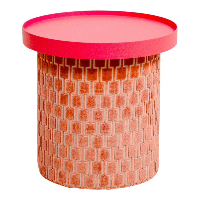 Round table with a vibrant red top and peach patterned base featuring a textured geometric design.