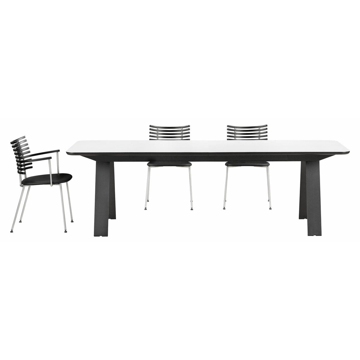 Stylish black and white dining table set with sleek, modern lines and patterned chrome chairs. Perfect for contemporary decor.