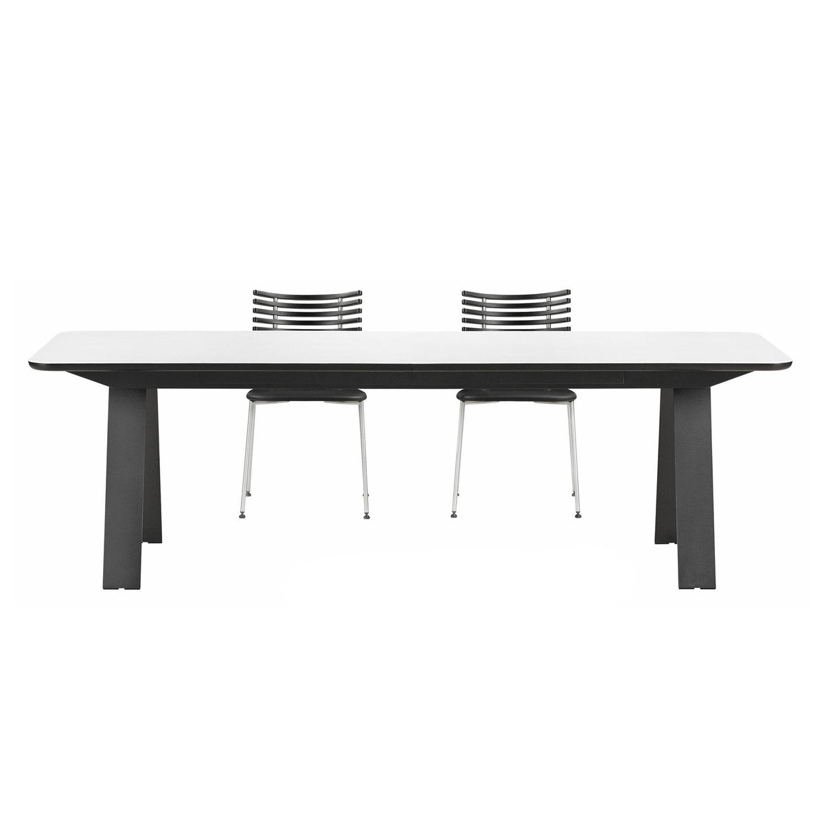 Modern white dining table with sleek gray legs and two stylish black and silver chairs. Clean lines and minimalist design.