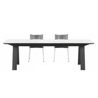 Modern white dining table with sleek gray legs and two stylish black and silver chairs. Clean lines and minimalist design.