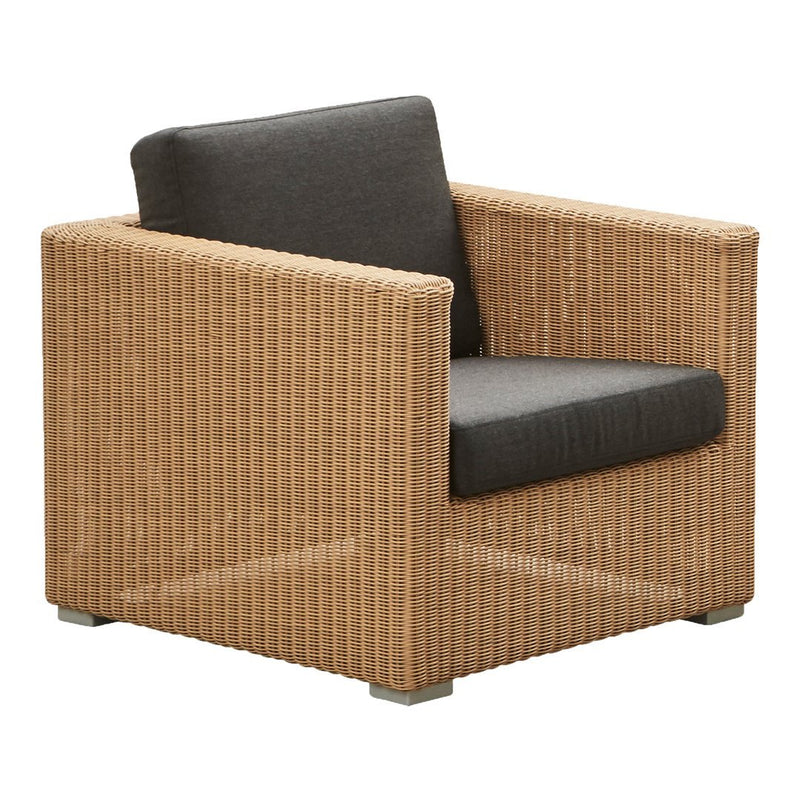 Natural woven rattan armchair with a sleek gray cushion, showcasing a modern, textured pattern. Ideal for outdoor spaces.