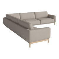 Beige upholstered sectional sofa with a sleek, modern design and light wooden legs, perfect for contemporary living spaces.