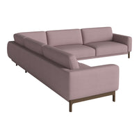 "Soft pink sectional sofa with a minimalist design and smooth texture, featuring clean lines and discreet legs."