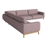 L-shaped sofa in soft mauve fabric with clean lines and natural wood legs, perfect for modern living spaces.