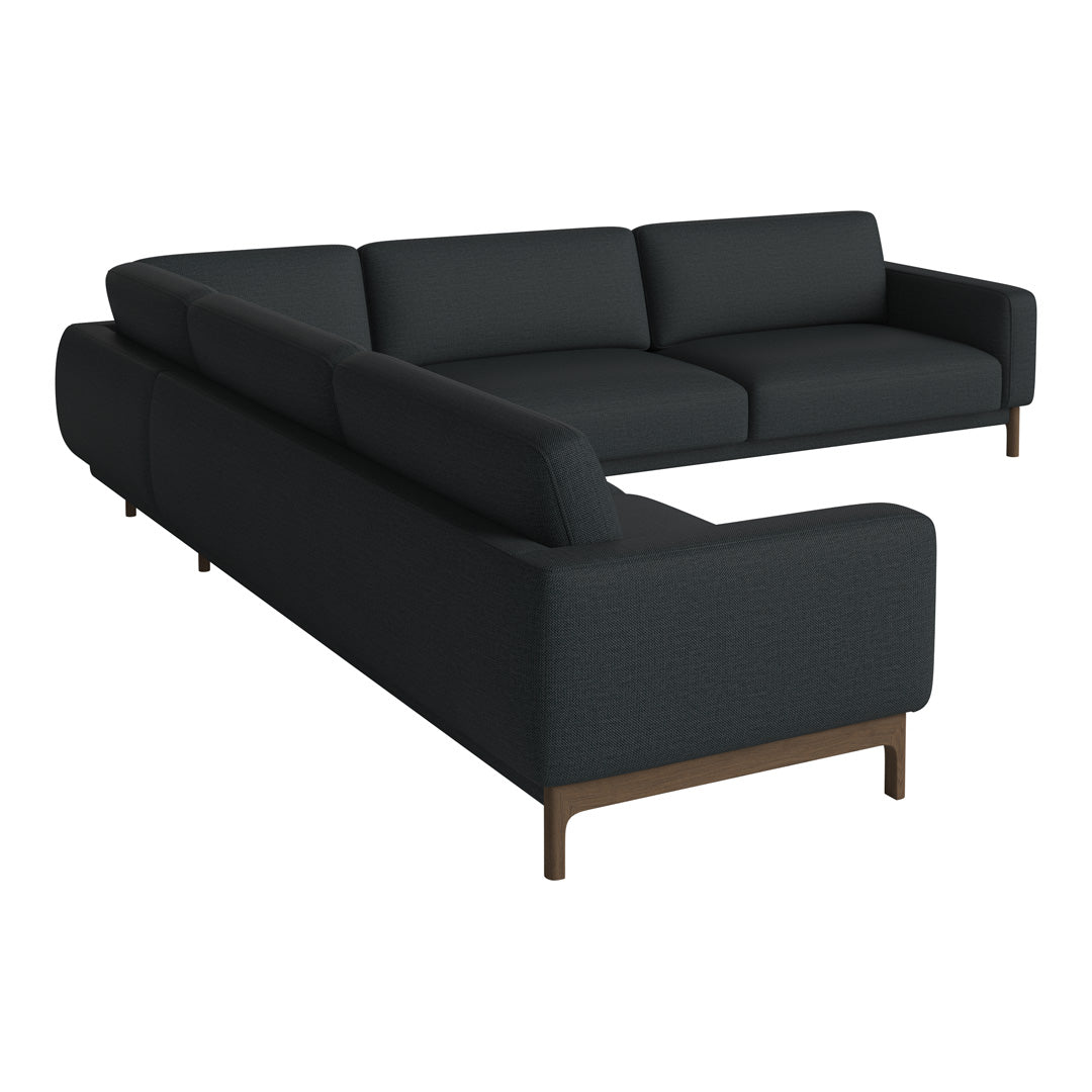 Modern L-shaped sofa in deep charcoal gray fabric with sleek wooden legs, offering a minimalist design and subtle texture.