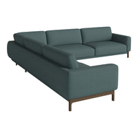 Teal sectional sofa with a smooth fabric texture and minimalist design, featuring sleek wooden legs.
