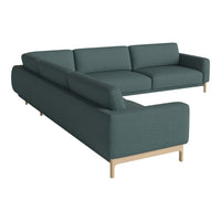Teal fabric sectional sofa with a smooth, modern design and light wood legs, perfect for contemporary living rooms.