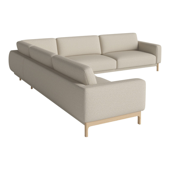 Beige sectional sofa with a smooth fabric texture and clean lines, complemented by light wooden legs.