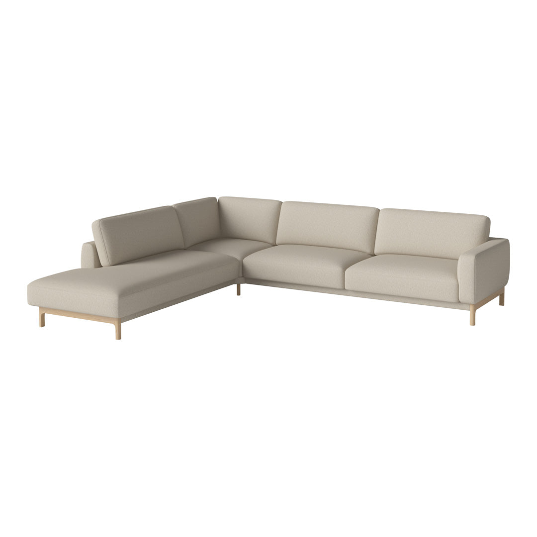 Light beige sectional sofa with smooth upholstery and natural wood legs, featuring a minimalist design.