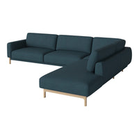 "Teal upholstered sectional sofa with clean lines and natural wood legs, perfect for modern living spaces."