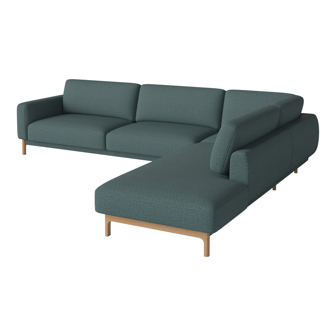 Teal sectional sofa with a textured pattern and wooden legs, perfect for modern living spaces.