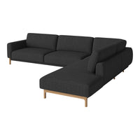 Dark gray sectional sofa with a minimalist design and wooden legs, featuring a smooth fabric texture.