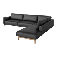 Black leather sectional sofa with smooth texture and light wood legs. Modern design complements any contemporary décor.