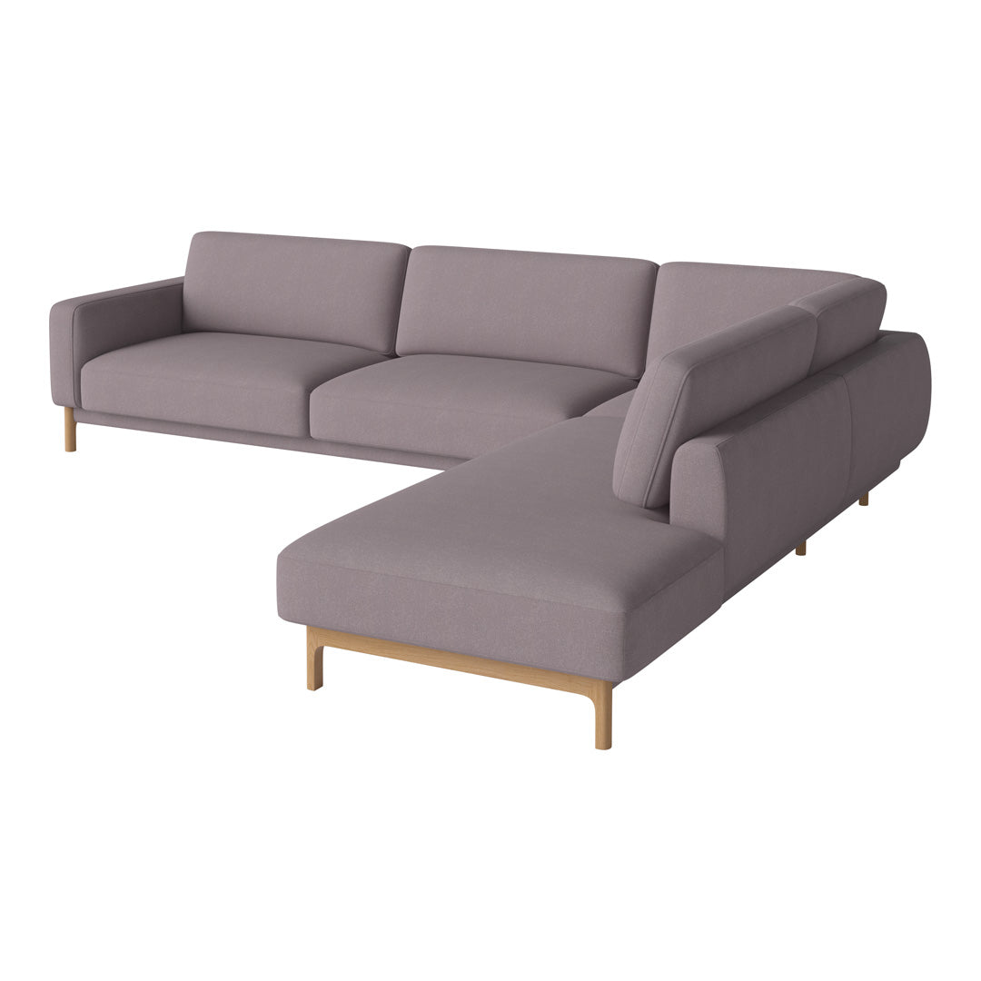 Gray sectional sofa with clean lines and minimalist design, featuring soft fabric and light wood legs.