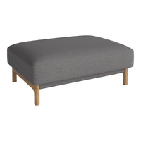 Gray upholstered ottoman with a smooth texture and light wood legs, perfect for modern decor.