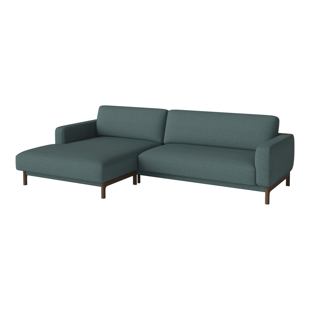 Teal sectional sofa with a smooth, solid upholstery and sleek wooden legs, perfect for modern living spaces.
