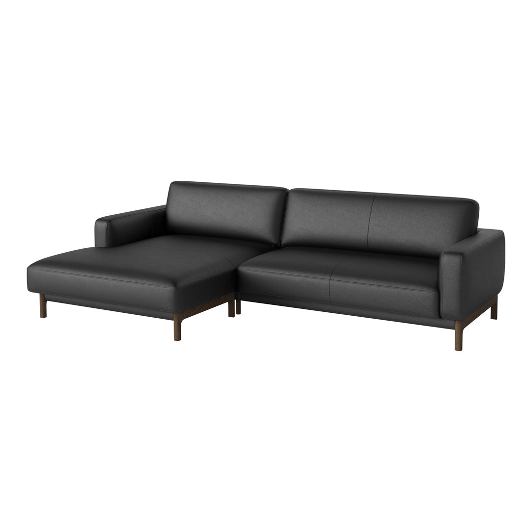 Black leather sectional sofa with sleek lines and wooden legs, perfect for modern living spaces.