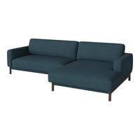 Dark teal fabric sofa with a sleek, modern design and simple wooden legs, perfect for contemporary decor.