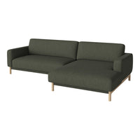 Dark green fabric sofa with minimalist design and light wooden legs, featuring solid color without patterns.