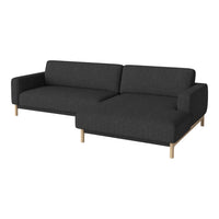 Modern black fabric sectional sofa with a minimalist design and light wood legs. Perfect for contemporary living spaces.