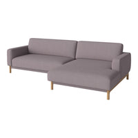 Light gray sectional sofa with a minimalist design and soft fabric, complemented by natural wood legs.