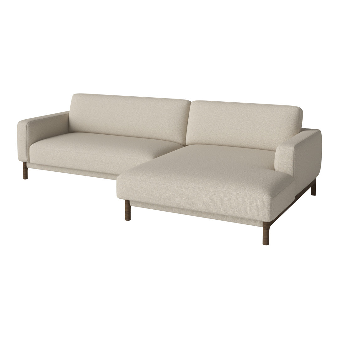 Neutral beige sectional sofa with a smooth, solid fabric and minimalist design, complemented by dark wood legs.