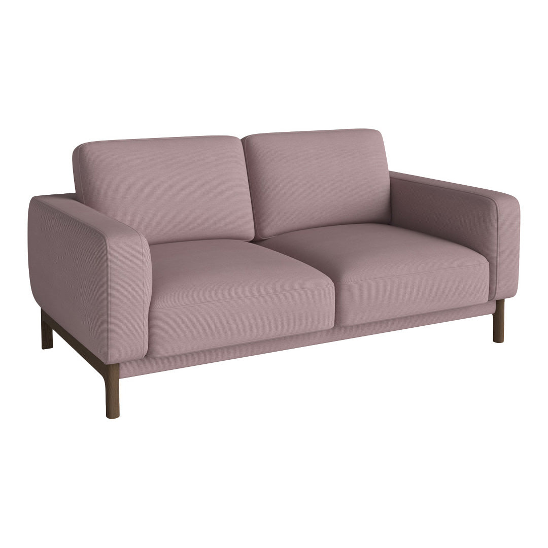 Soft blush pink fabric sofa with clean lines and minimal pattern, featuring a dark wooden base. Ideal for modern decor.