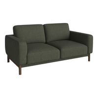 Soft dark green fabric sofa with a minimalist design and smooth, modern lines. Ideal for contemporary interiors.