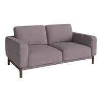 Modern two-seater sofa in soft lavender fabric with smooth, minimalist design and dark wooden legs.