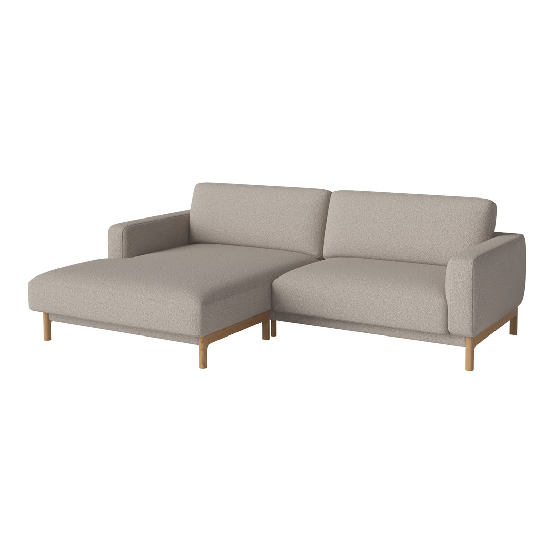 Light beige sectional sofa with a simple, modern design and wooden legs, perfect for contemporary interiors.