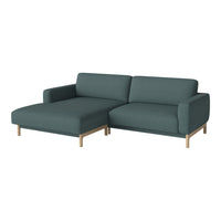 Modern teal sectional sofa with wooden legs, showcasing a sleek, minimalist design and solid color upholstery.