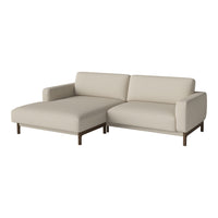Beige sectional sofa with clean lines and a minimalist design, featuring a subtle texture and dark wood legs.
