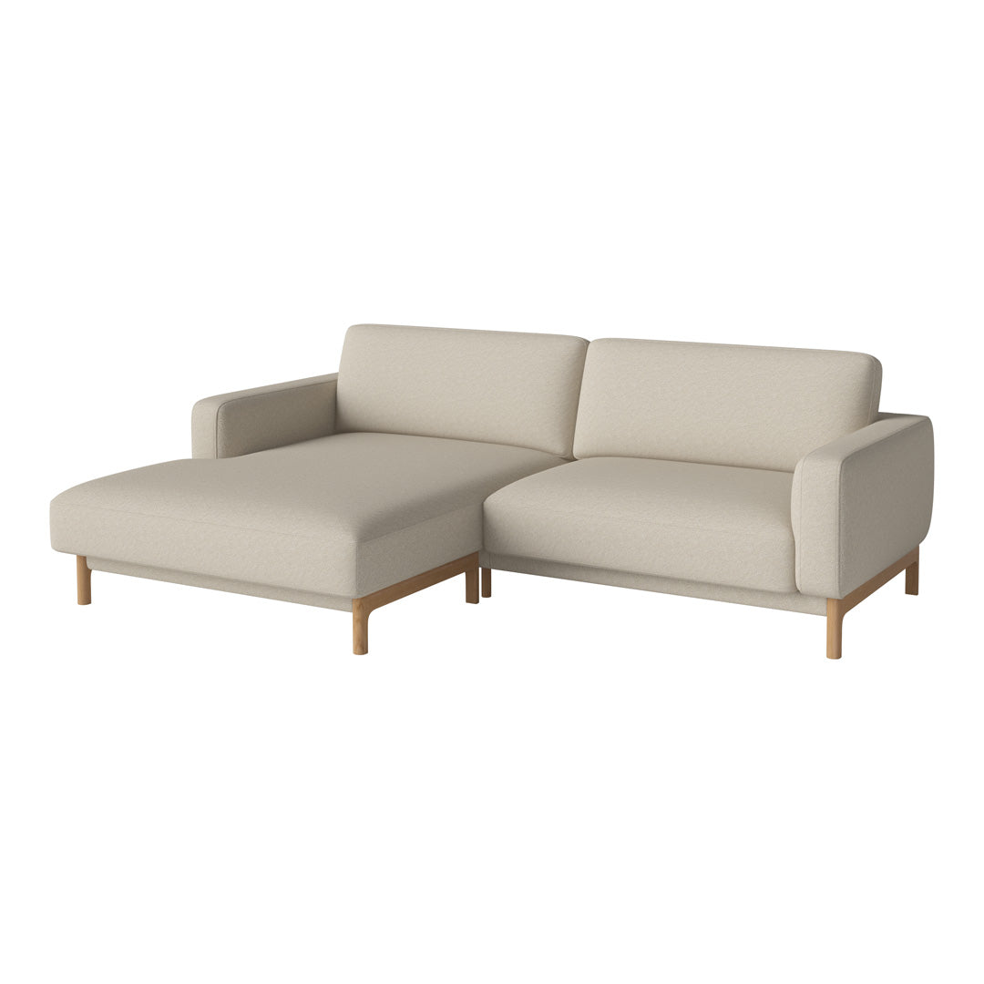 Light beige sectional sofa with minimalist design and natural wood legs, featuring a clean, smooth upholstery pattern.