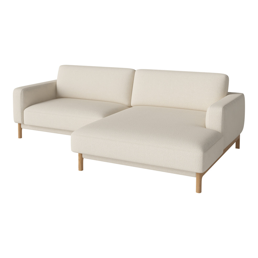 Cream-colored sectional sofa with a minimalist design and wooden legs, perfect for modern decor.