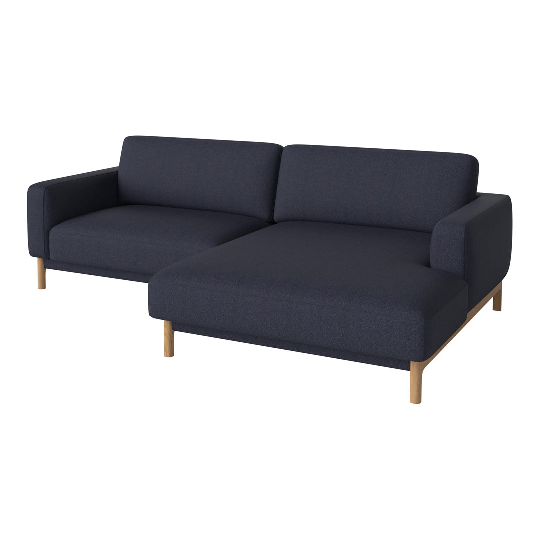 Modern dark navy blue sofa with a textured fabric pattern and light wooden legs. Stylish and contemporary design.