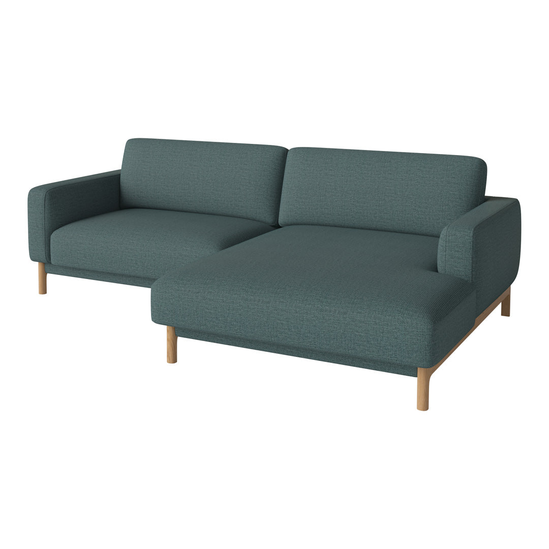 Teal fabric sectional sofa with minimalist design and light wood legs, featuring a smooth, solid texture.