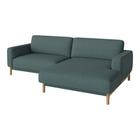 Teal fabric sectional sofa with minimalist design and light wood legs, featuring a smooth, solid texture.