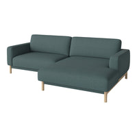 Teal green fabric sofa with a modern design and light wooden legs, featuring a solid, textured pattern.