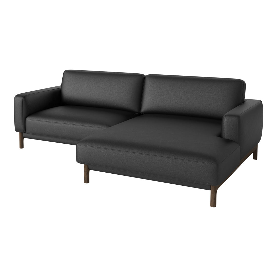 "Modern black sofa with a sleek, textured fabric and clean lines, featuring a low-profile design and sturdy wooden legs."