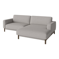 Light grey sectional sofa with a minimalist design and smooth fabric texture, complemented by wooden legs.