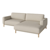Light beige sectional sofa with a smooth, solid fabric pattern and natural wood legs. Ideal for modern decor.