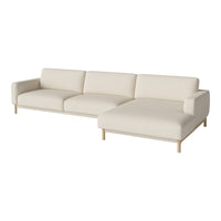 Beige sectional sofa with a minimalist design and soft fabric, featuring a light wood base. Perfect for modern decor.