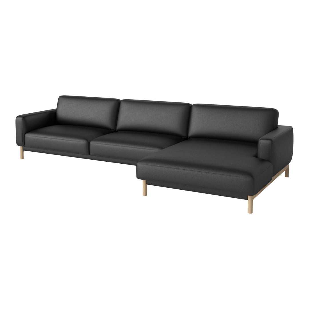 Black modular sofa with clean lines and smooth texture, accented by light wooden legs.