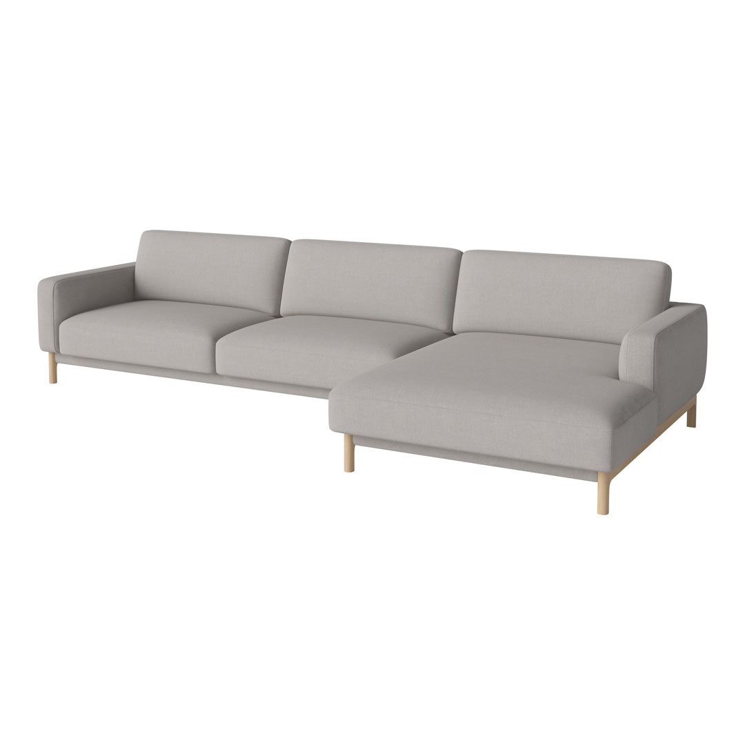 Light gray sectional sofa with clean lines and natural wood legs, featuring a minimalist design and soft upholstery.