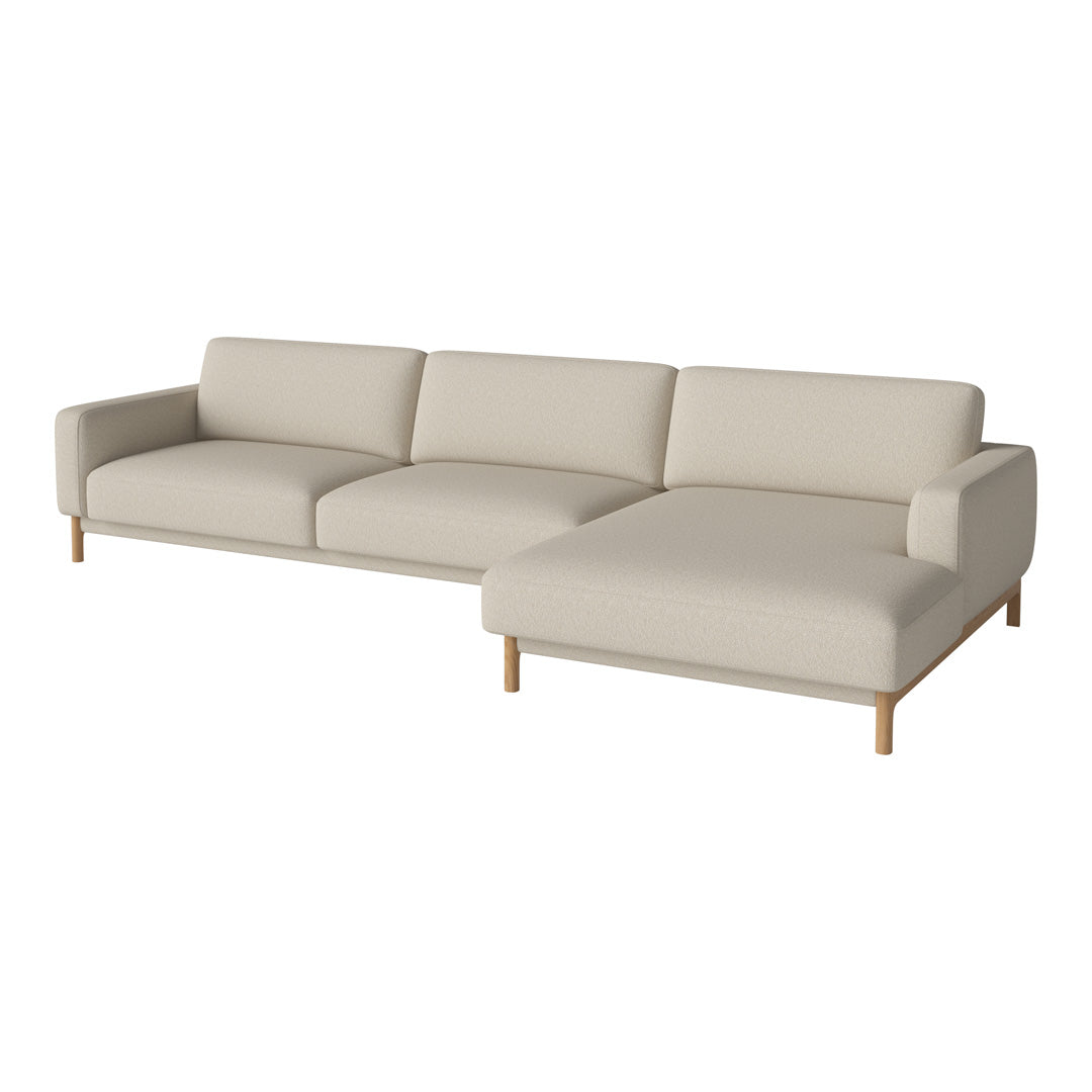 Cream sectional sofa with a minimalist design and light wood legs, featuring smooth upholstery and clean lines.